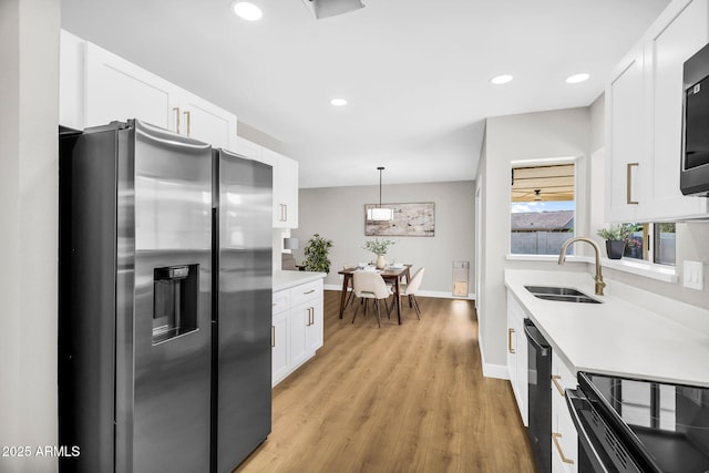 25810 S Boxwood Dr, Sun Lakes, AZ 85248 - kitchen featuring black appliances, a sink, light wood-style flooring, light countertops, and recessed lighting