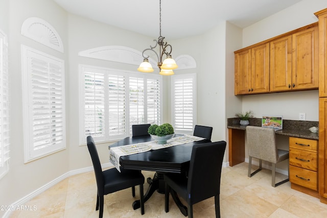 dining space featuring light tile patterned floors, baseboards, a chandelier, and built in study area