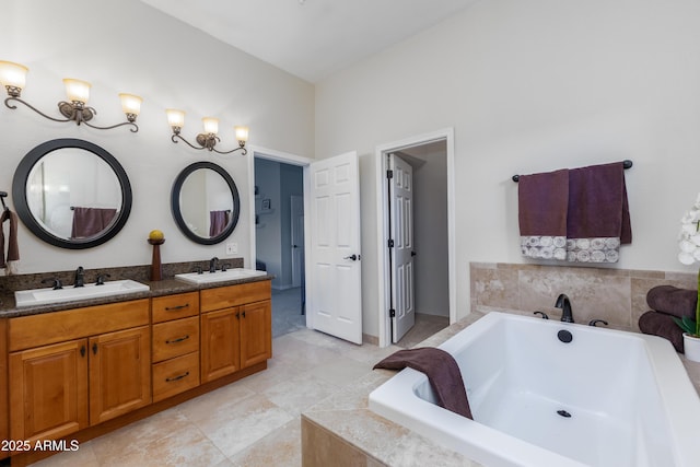 full bath featuring double vanity, tile patterned flooring, a garden tub, and a sink