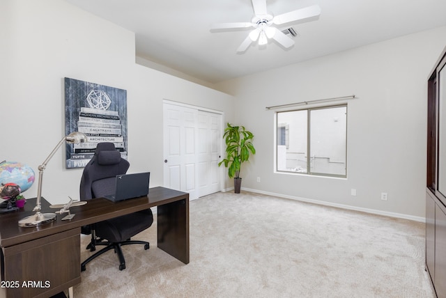 office space with visible vents, baseboards, light colored carpet, and a ceiling fan