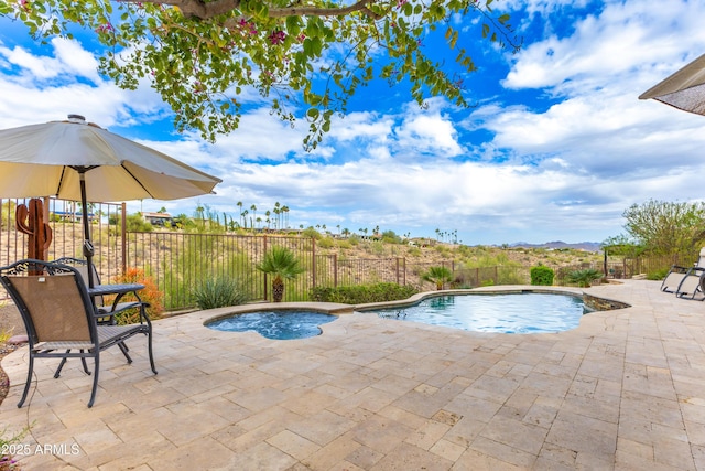 view of pool with a fenced in pool, an in ground hot tub, a fenced backyard, and a patio area