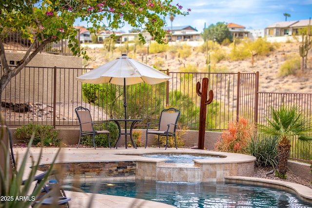 view of swimming pool featuring a residential view, an in ground hot tub, and fence