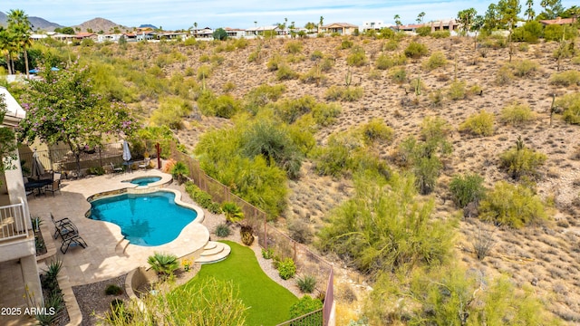 view of swimming pool featuring a fenced in pool, fence, a patio, a mountain view, and an in ground hot tub