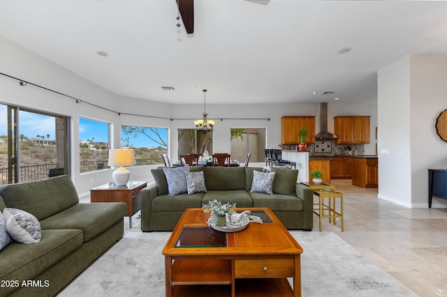 living room featuring recessed lighting, visible vents, ceiling fan with notable chandelier, and baseboards