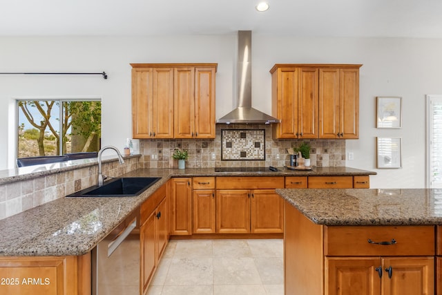 kitchen featuring dark stone counters, a sink, stainless steel dishwasher, wall chimney range hood, and black electric cooktop