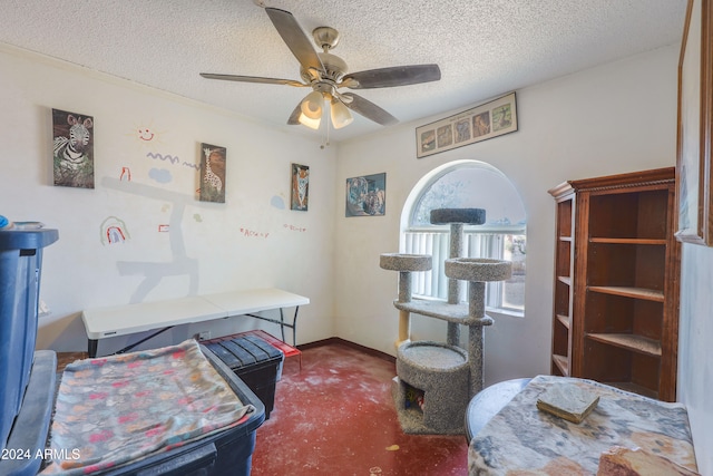 bedroom with a textured ceiling and ceiling fan