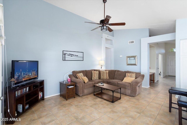 tiled living room with ceiling fan and lofted ceiling