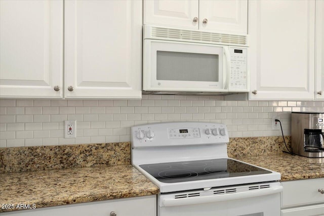 kitchen featuring light stone countertops, white appliances, tasteful backsplash, and white cabinetry