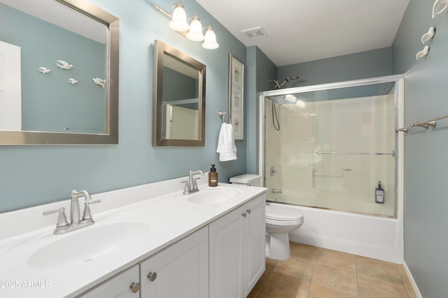 full bathroom with tile patterned flooring, vanity, toilet, and enclosed tub / shower combo