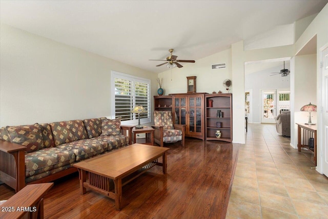 living room featuring ceiling fan and vaulted ceiling