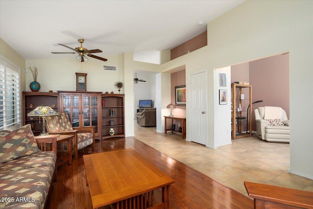 living room with ceiling fan and light wood-type flooring