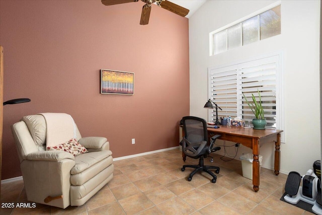 tiled home office with ceiling fan and high vaulted ceiling