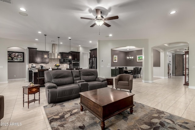 living area featuring recessed lighting, arched walkways, and light tile patterned flooring