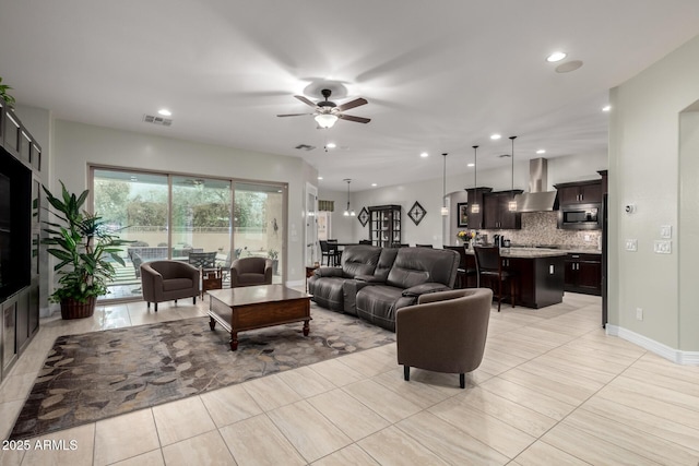 living area featuring light tile patterned floors, visible vents, baseboards, ceiling fan, and recessed lighting