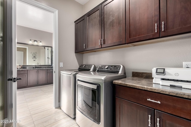laundry area featuring laundry area, separate washer and dryer, and a sink