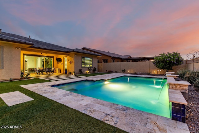 pool at dusk featuring a fenced backyard, a lawn, a fenced in pool, and a patio