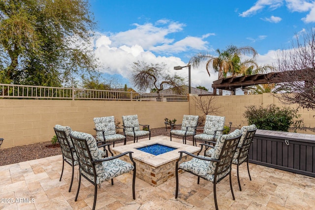 view of patio featuring an outdoor fire pit and a fenced backyard