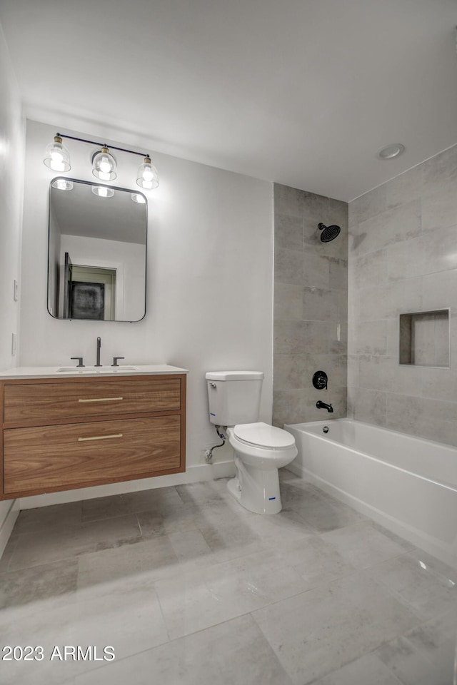 full bathroom with vanity, tiled shower / bath combo, and toilet