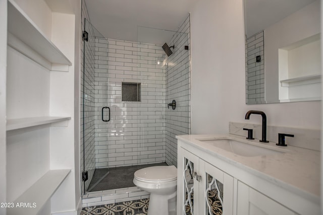 bathroom with vanity, toilet, and a shower with door