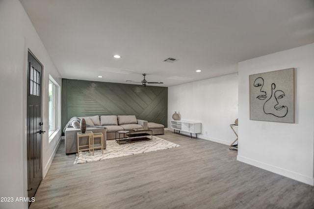 living room with wood-type flooring and ceiling fan