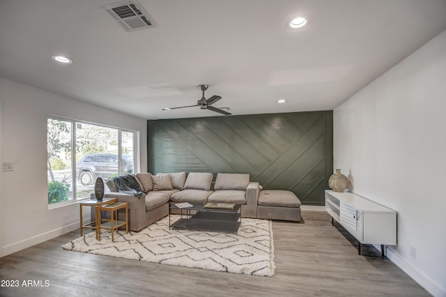 living room with light hardwood / wood-style floors and ceiling fan