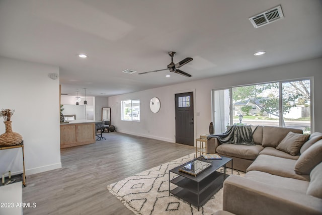 living room featuring ceiling fan and light wood-type flooring