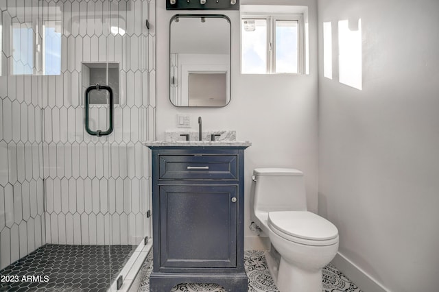 bathroom featuring tile patterned floors, vanity, toilet, and walk in shower