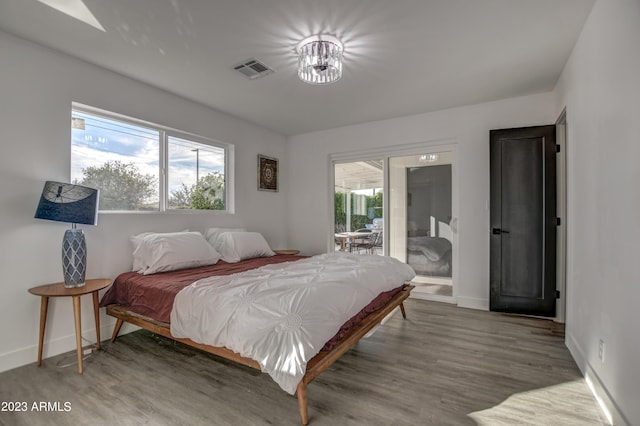 bedroom featuring hardwood / wood-style floors and access to outside