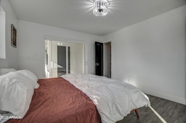 bedroom with dark wood-type flooring