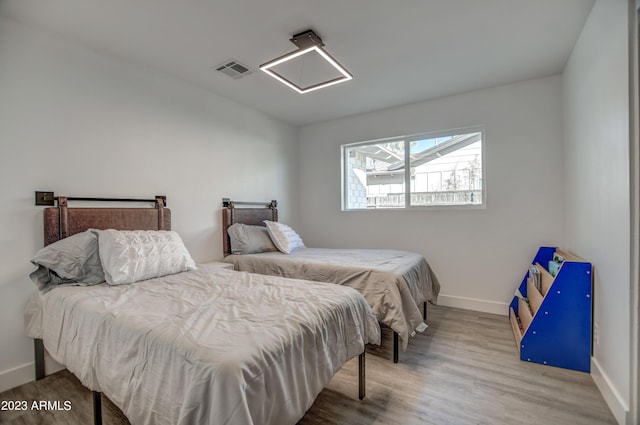 bedroom with hardwood / wood-style flooring