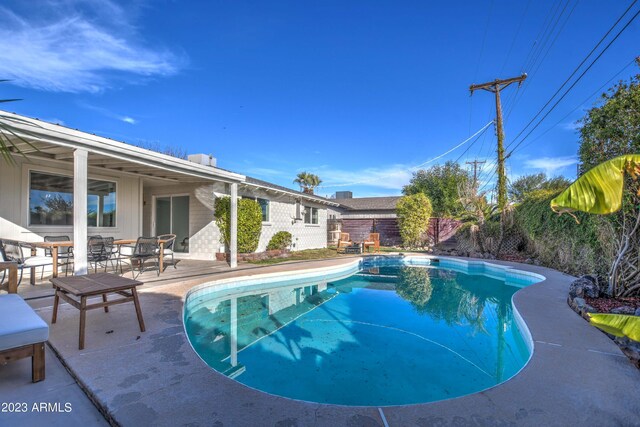 view of swimming pool with a patio