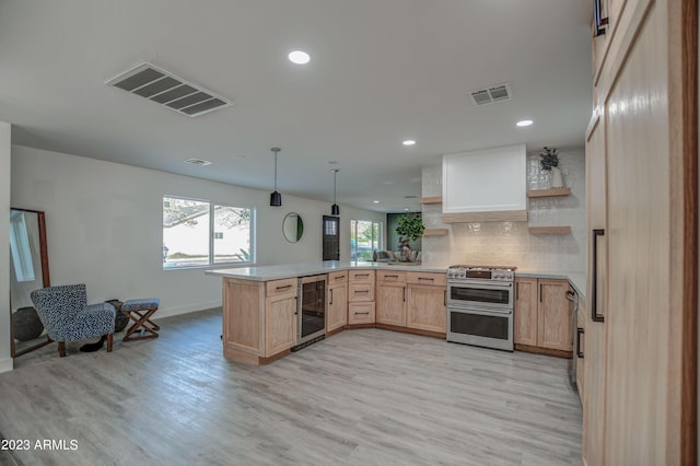 kitchen with kitchen peninsula, light wood-type flooring, light brown cabinets, range with two ovens, and wine cooler