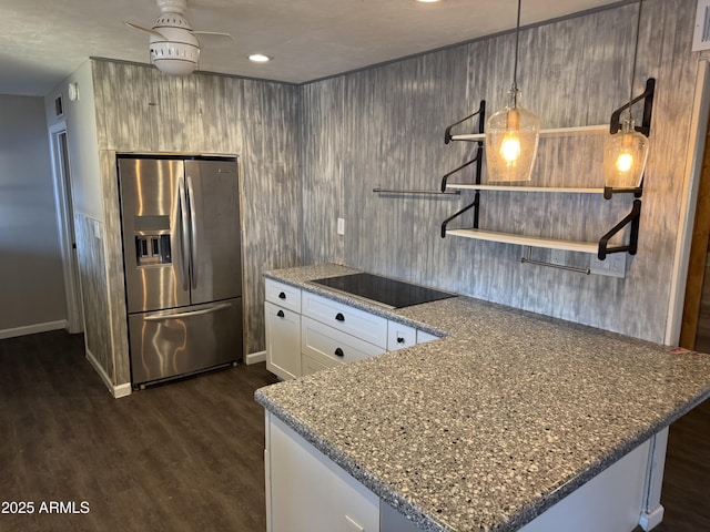 kitchen featuring stainless steel fridge, hanging light fixtures, black electric stovetop, white cabinets, and dark hardwood / wood-style flooring