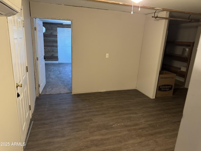 spare room featuring dark hardwood / wood-style floors and a wall mounted AC