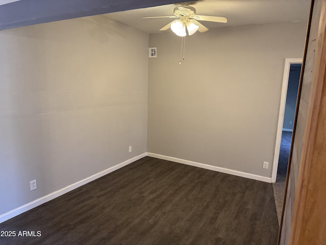 empty room with dark hardwood / wood-style flooring and ceiling fan