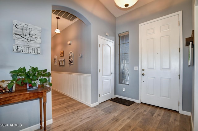 foyer entrance featuring hardwood / wood-style floors and vaulted ceiling