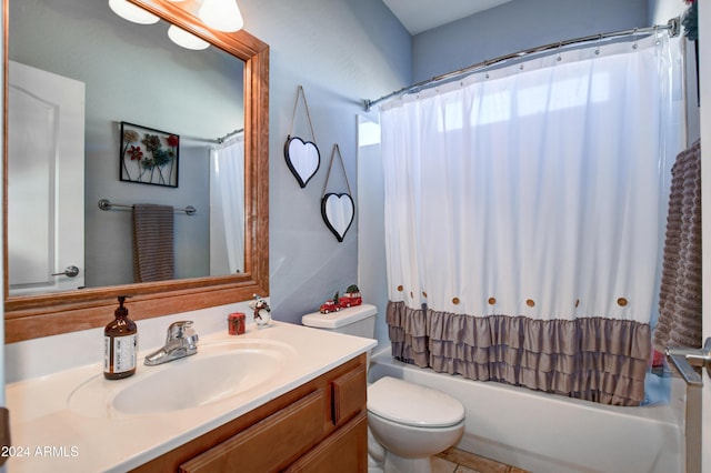 full bathroom with tile patterned flooring, shower / bath combo with shower curtain, vanity, and toilet