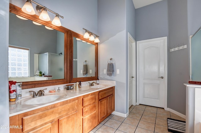 bathroom featuring tile patterned flooring, a high ceiling, vanity, and walk in shower