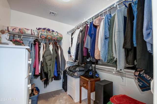 spacious closet featuring light carpet