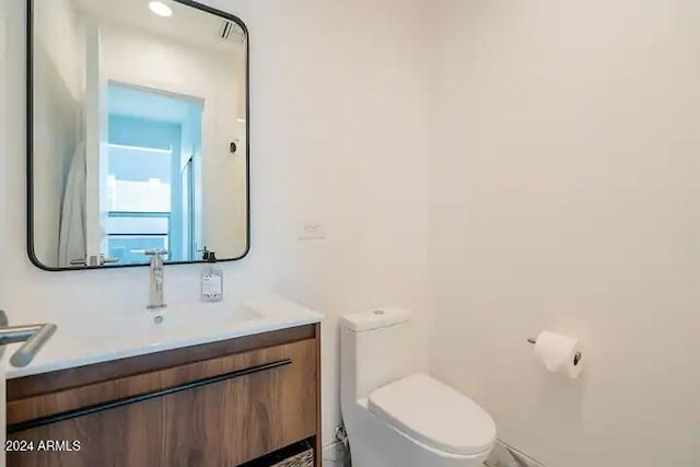 bathroom featuring vanity and toilet