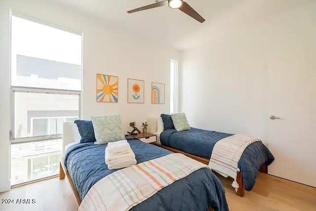 bedroom with hardwood / wood-style floors and ceiling fan