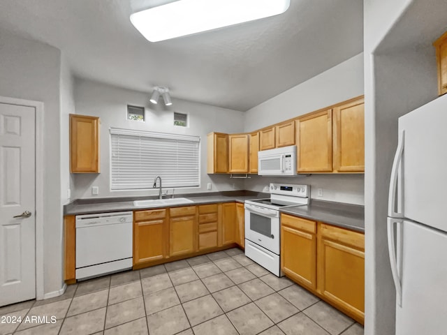 kitchen with light tile patterned flooring, white appliances, and sink