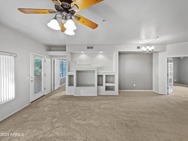 unfurnished living room featuring light colored carpet and ceiling fan with notable chandelier