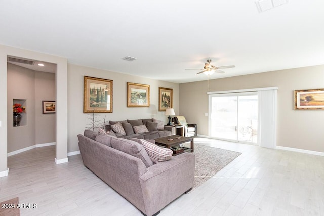 living room with light hardwood / wood-style flooring and ceiling fan