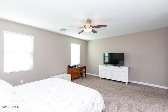 bedroom with ceiling fan and light carpet