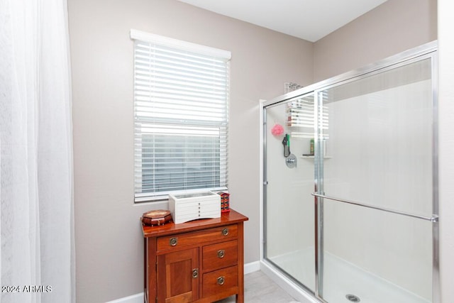 bathroom with a shower with door