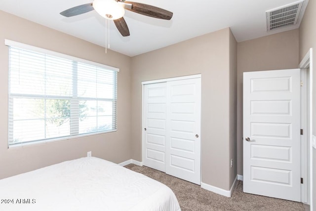 bedroom with carpet, a closet, and ceiling fan