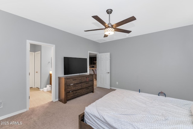 bedroom with light colored carpet, ensuite bath, and ceiling fan