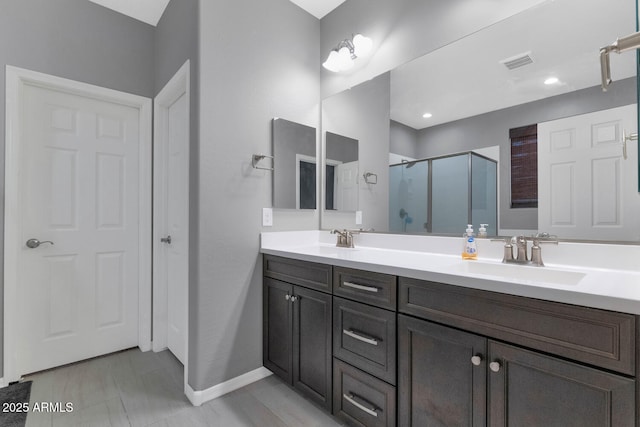 bathroom featuring vanity and an enclosed shower