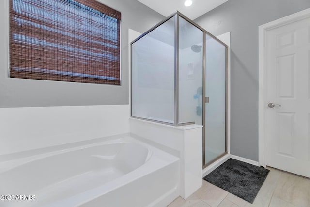 bathroom with separate shower and tub